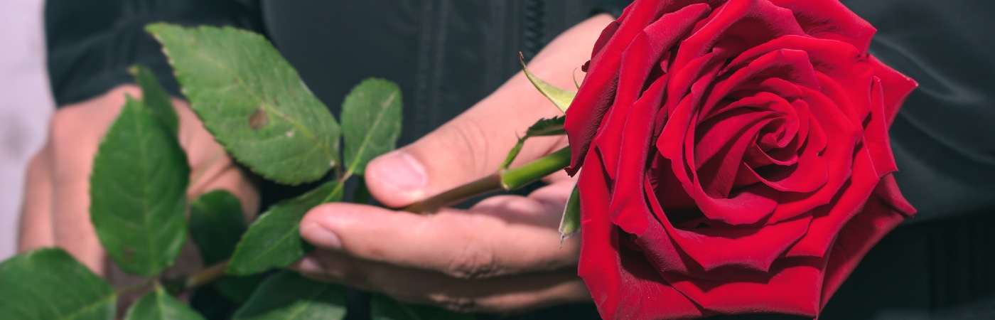 Man holding a rose in mourning