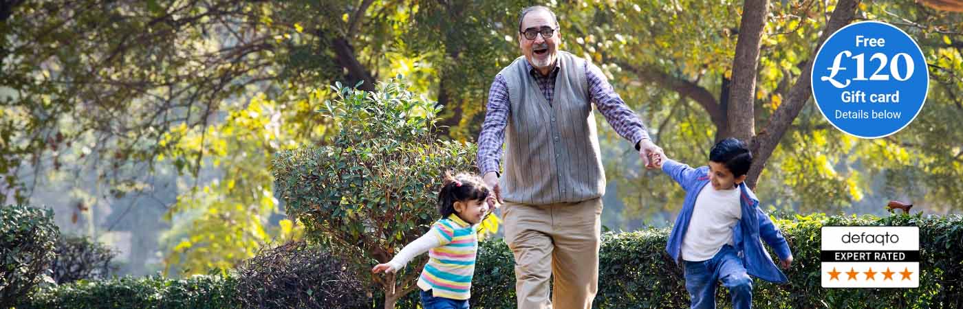 Grandfather playing with his grandchildren in the park