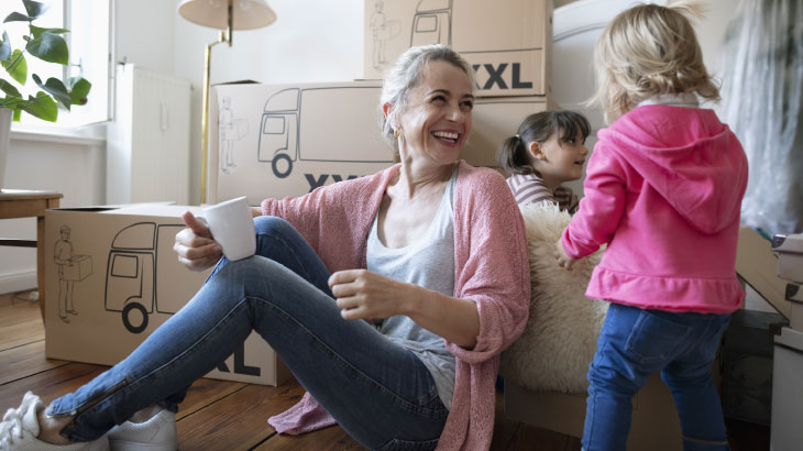 Woman sitting on floor next to boxes