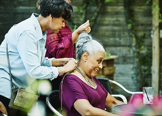 Women styling another women's hair