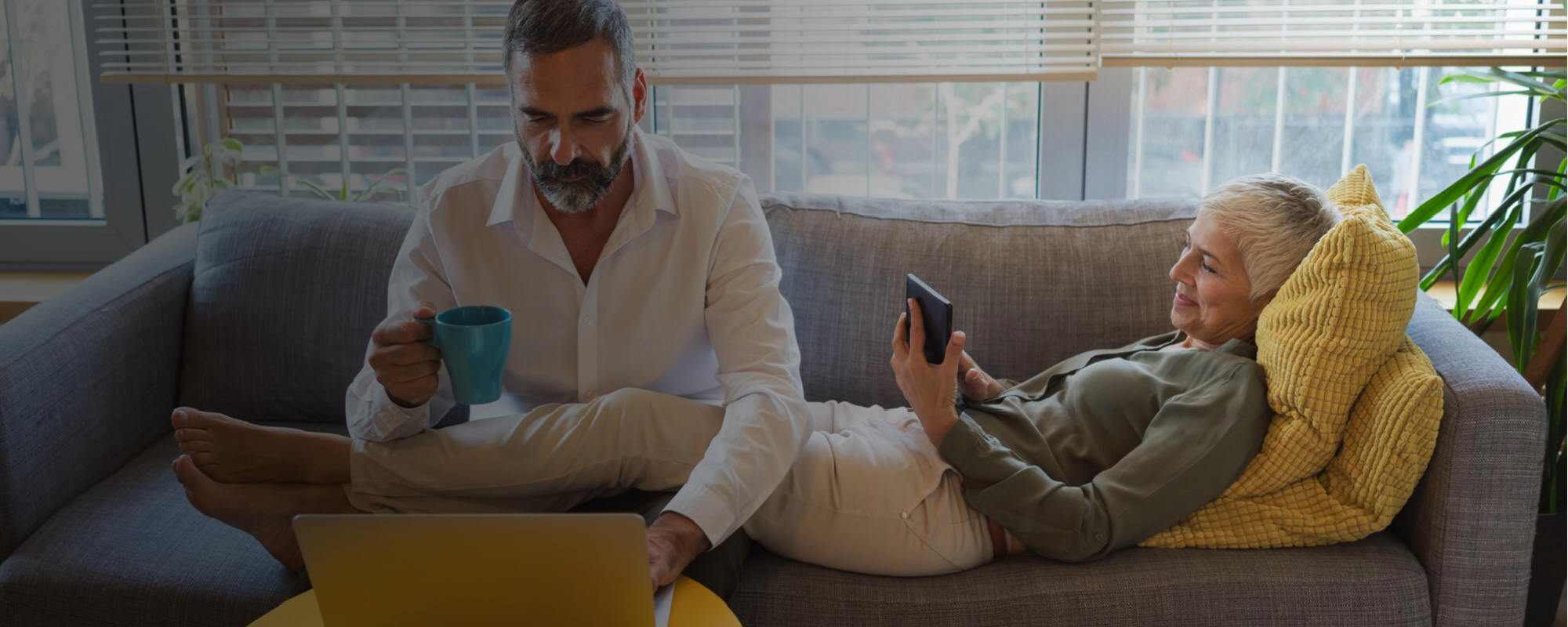 Image of couple researching on laptop