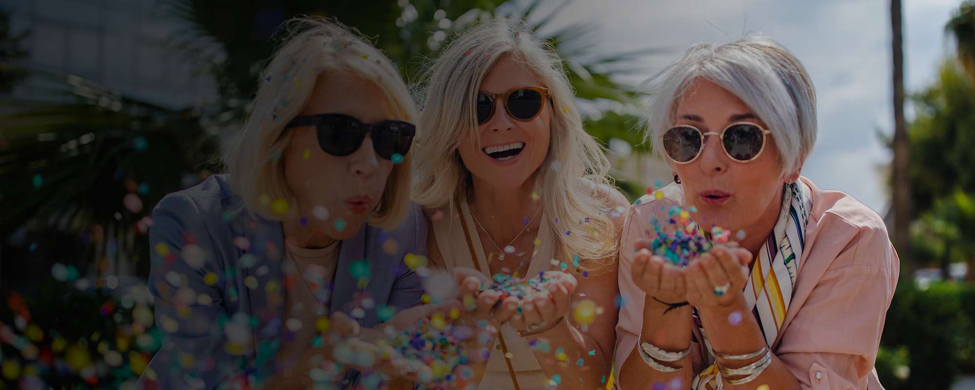 Women blowing confetti