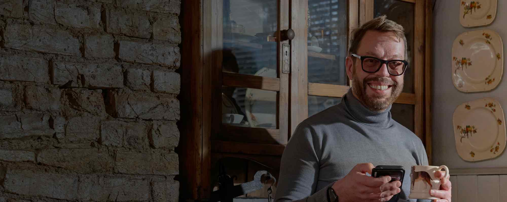 Robert relaxing in his kitchen with a cup of tea