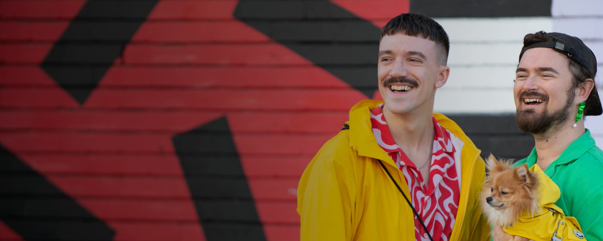 Two guys smiling in the street