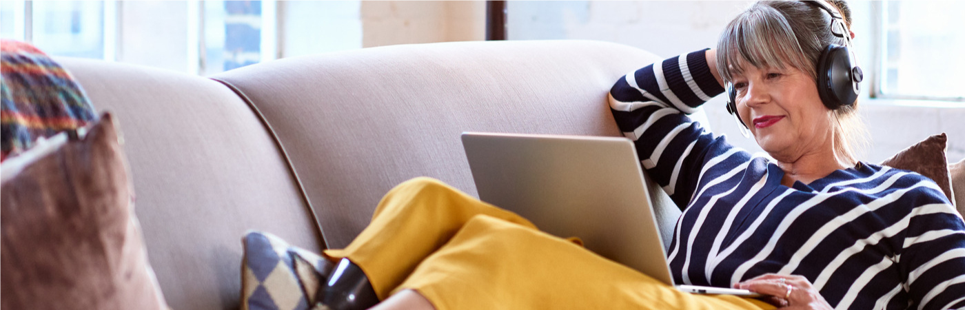 Woman ising laptop on couch