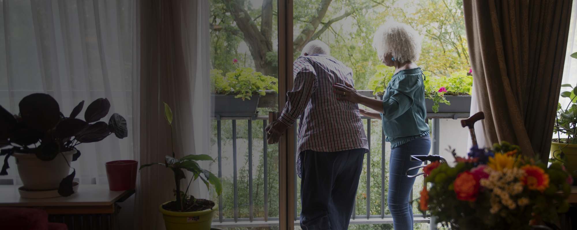 Image of an older woman helping her elderly father