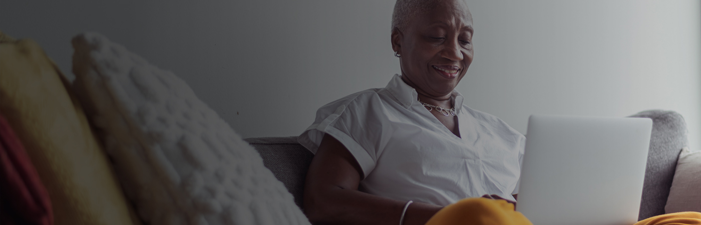 Woman on sofa with laptop