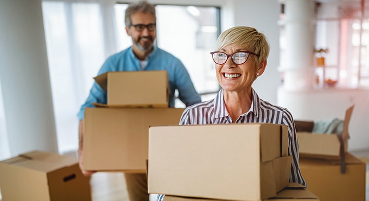 Man and woman carrying boxes