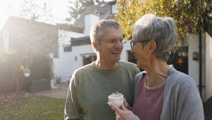 Happy couple outside their home