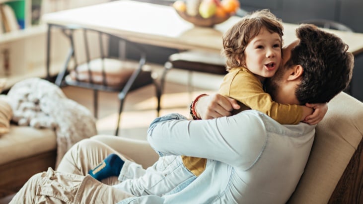 Man with son sitting on sofa