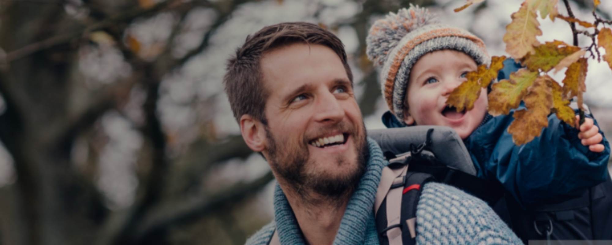 Father carrying child on back